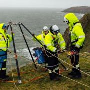 A Coastguard rescue team in training for a cliff rescue.