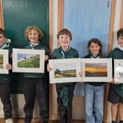 Jake, Eli, George, Megan and Oscar with their photographs.