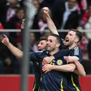 John McGinn, front, celebrates his Scotland goal in Warsaw (Rafal Oleksiewicz/PA)