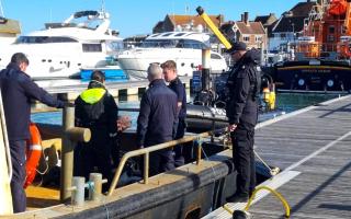 Police on board the seized boat Yvonne T in Yarmouth on Sunday.